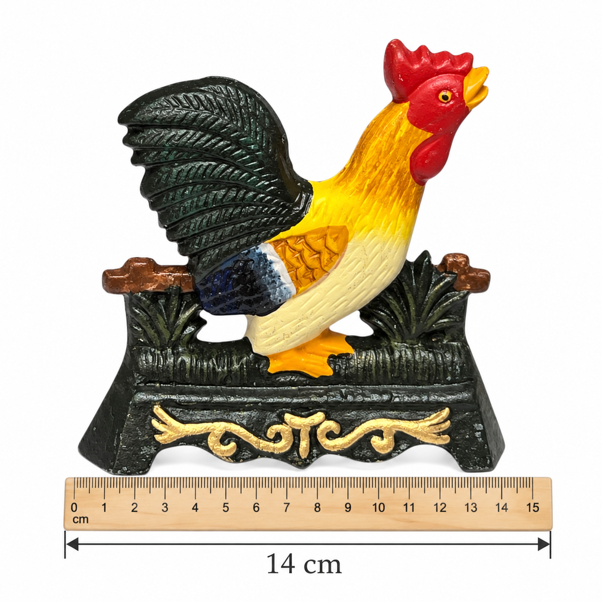A colourful decorative rooster figurine doorstop perched on a black base with gold scrollwork, shown against a white background with a wooden ruler below indicating 14 cm width.