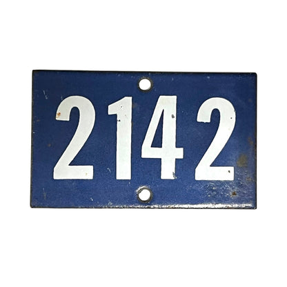 Blue enamel door number 2142 on a white background 