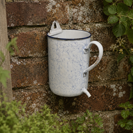 French enamel vintage garden wall mounted planter or kitchen bathroom storage pot, ideal for a rustic country cottage on a stone rustic  wall