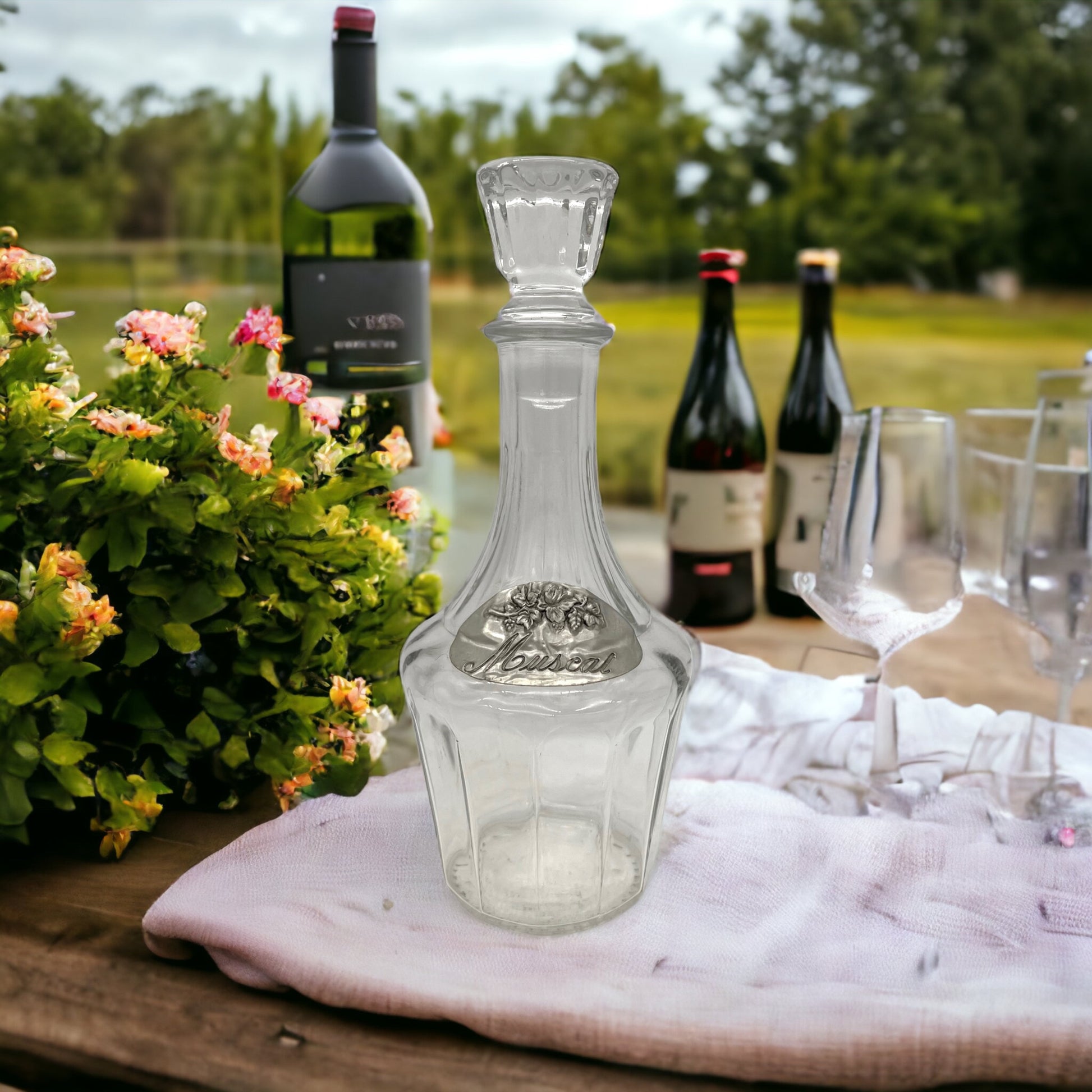 image French wine decanter on a table in a garden 