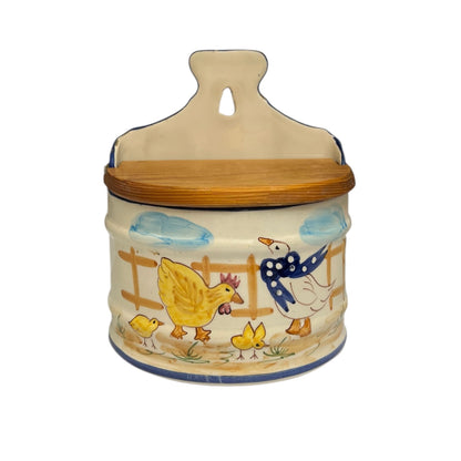 French ceramic salt pig on, farmyard decoration and a wooden lid on a white background 