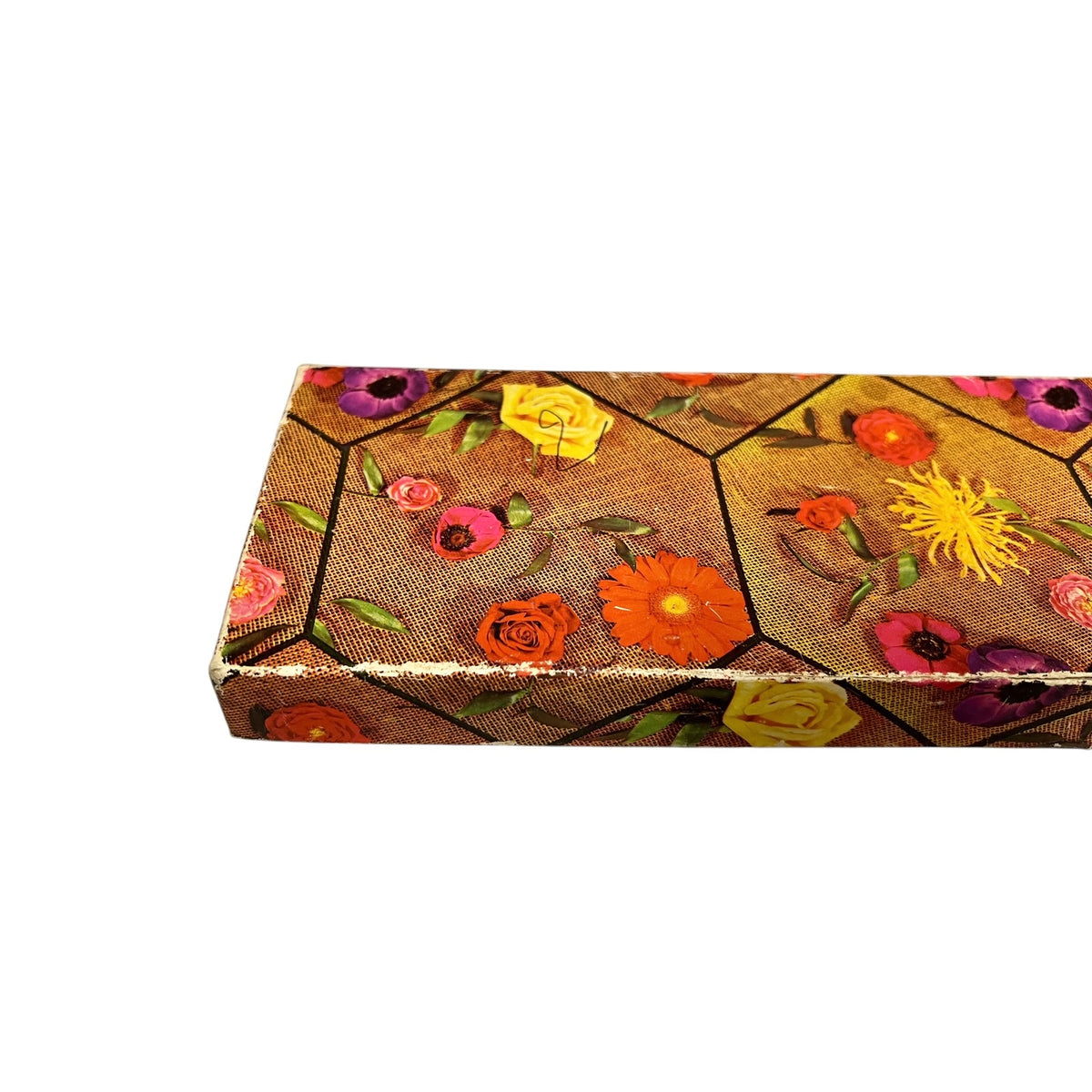 A rectangular box with a brown honeycomb patterned surface decorated with colorful pressed flowers, shown on a plain white background.