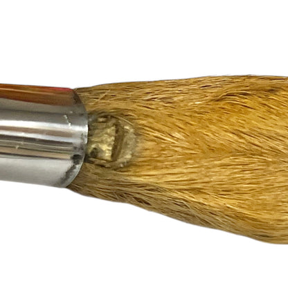 Close-up of a deer hoof handle and metallic ferrule against a plain white background.