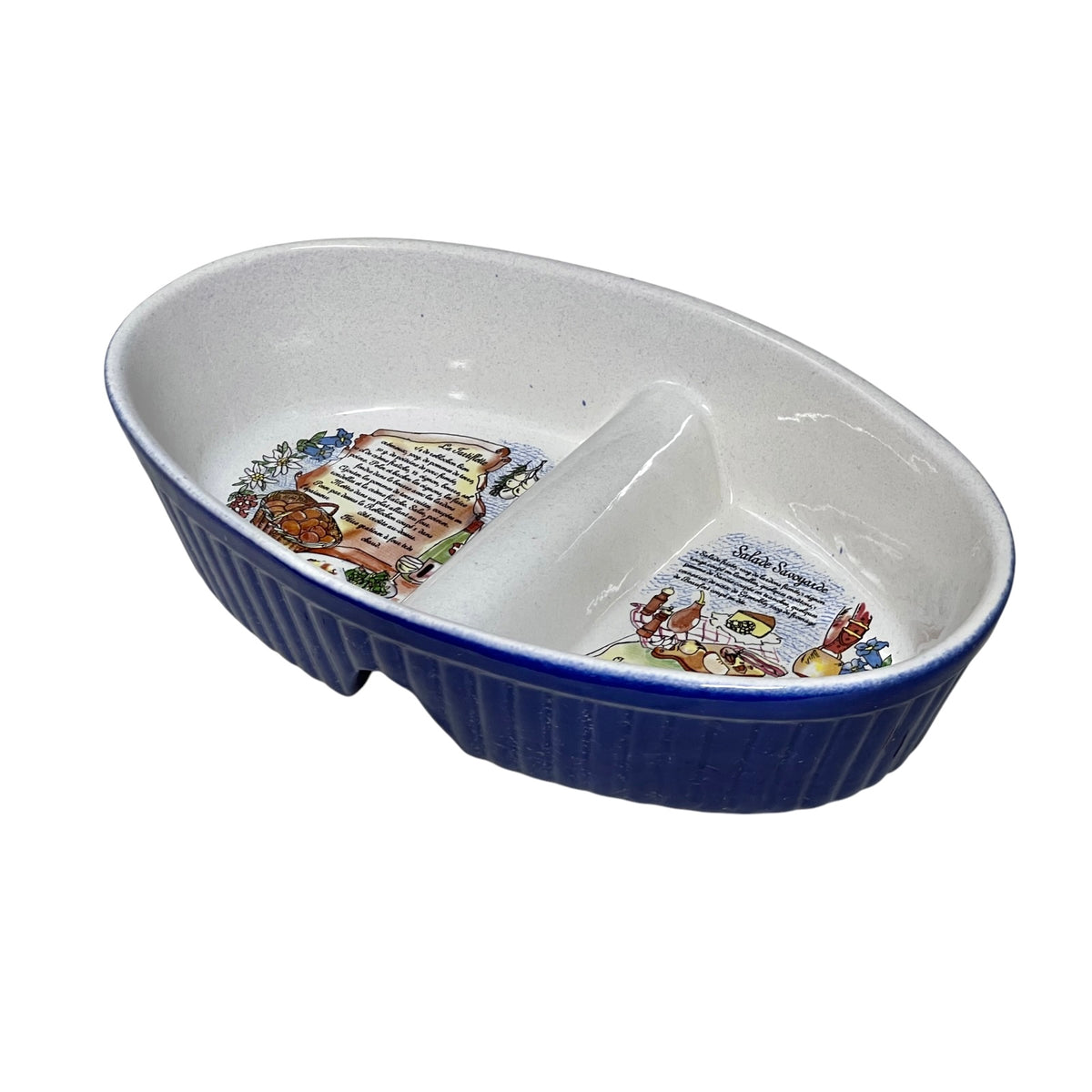 An oval ceramic tartiflette dish with a ribbed navy blue exterior and a white glazed interior, featuring printed illustrations and text of the traditional recipe 