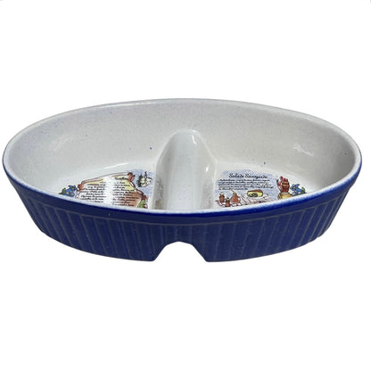 An oval ceramic divided serving dish with a ribbed dark blue exterior and a white interior, featuring printed illustrations and text on the base.