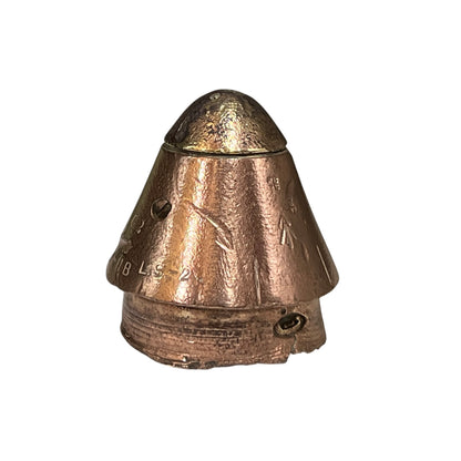 A small metallic brass fuse paperweight with a conical top and textured surface, photographed against a plain white background.