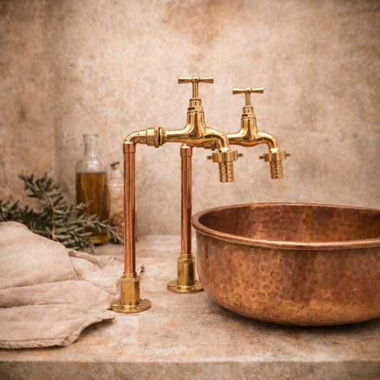 Copper sink with vintage-style faucet on a neutral background