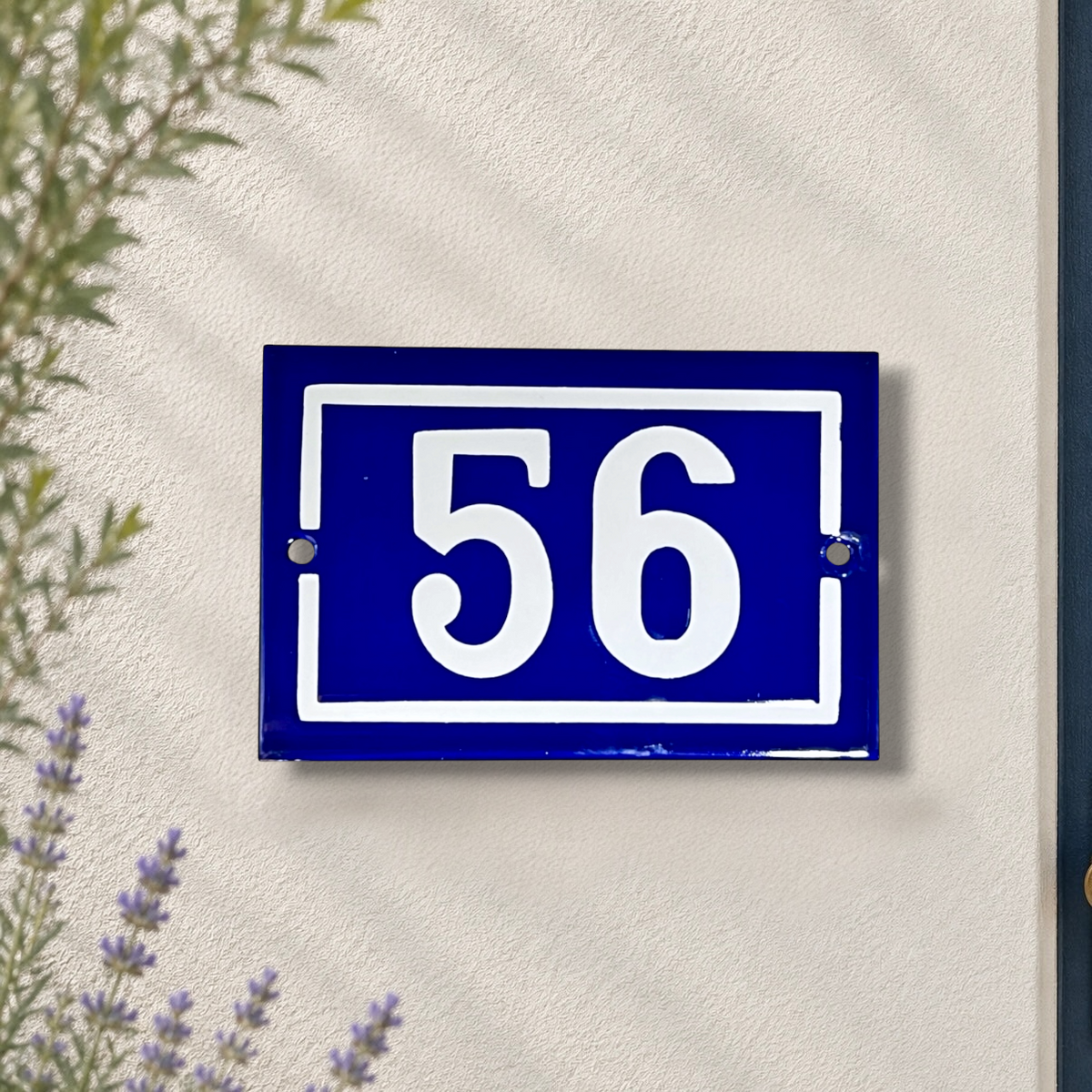 French blue and white door number 56 on a whitewashed wall 