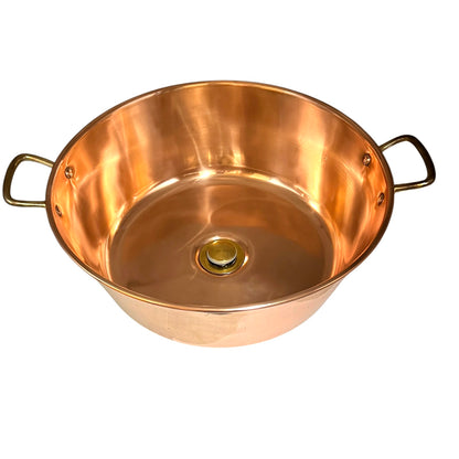 Copper up cycled cloakroom sink with brass handles and a brass drain on a white background 