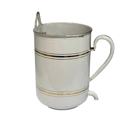 A vintage white ceramic pitcher with gold stripes and a metal pouring spout, shown on a plain white background.