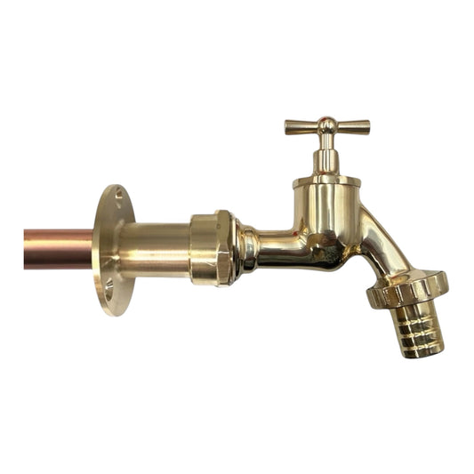 A brass wall faucet with a cross handle and a hose bib outlet, shown with a copper pipe sleeve on a plain white background.