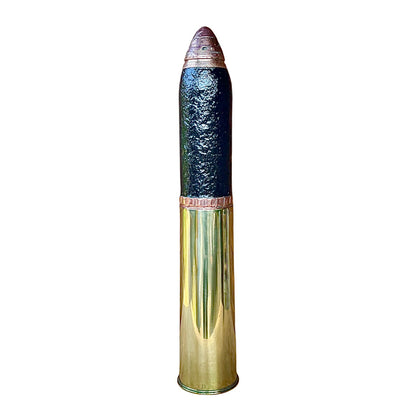 A WW1 18 pounder consisting of a brass shell, iron shrapnel and brass fuse on a white background 