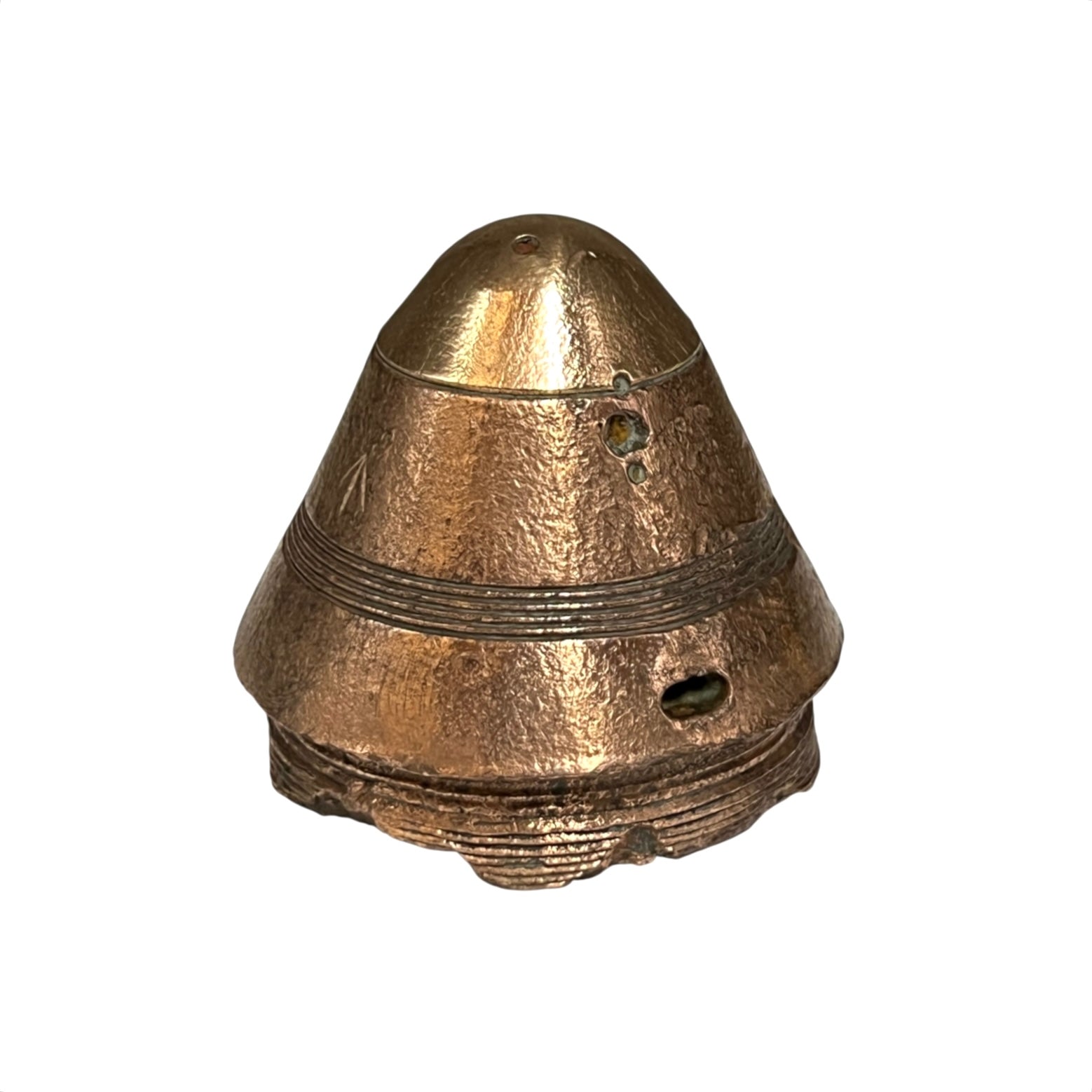 A small British WW1 brass fuse paperweight with a textured finish on a white background 