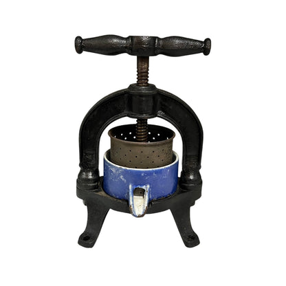 Vintage French cast iron metal press with a blue container on a white background