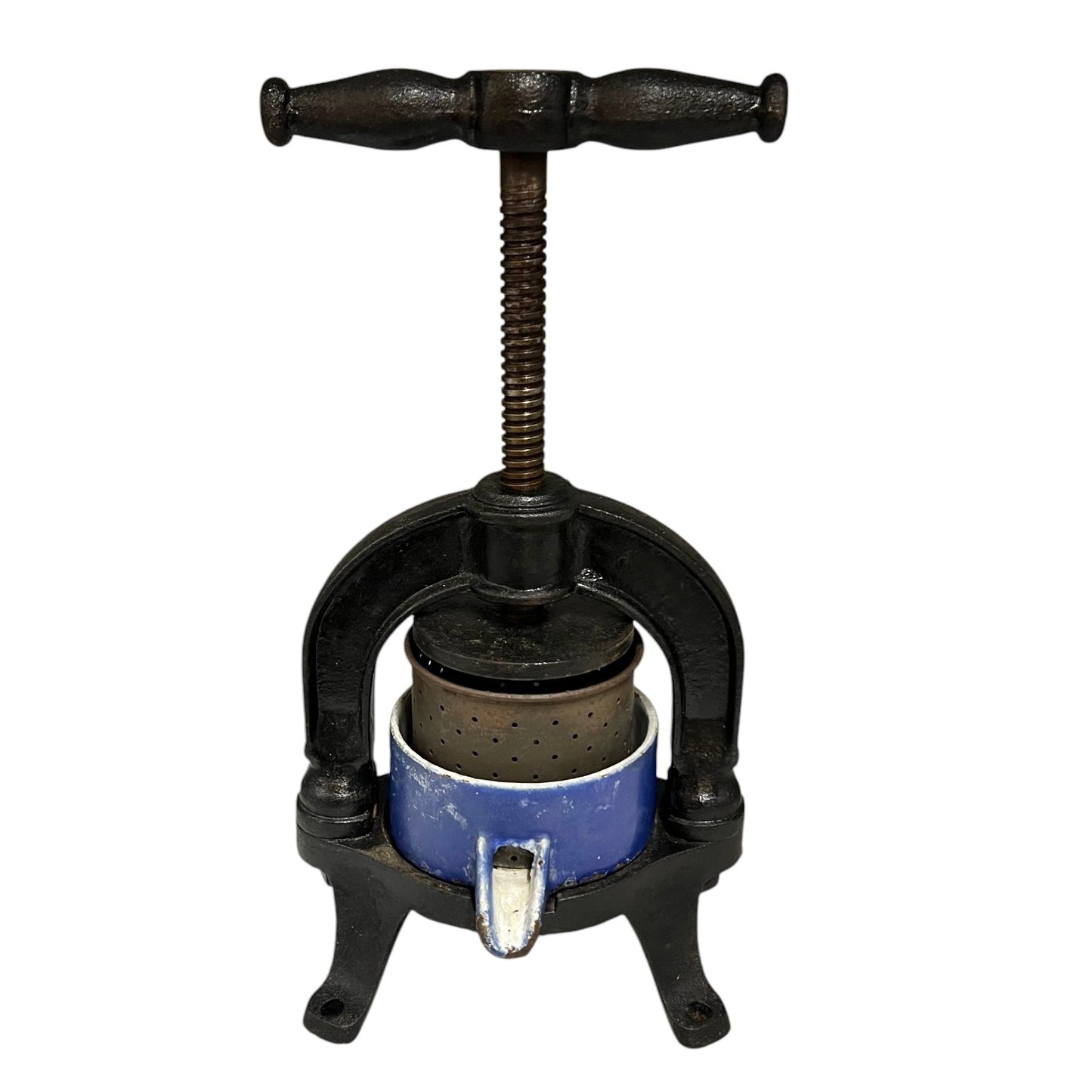 Vintage cast iron olive press with a blue container on a white background