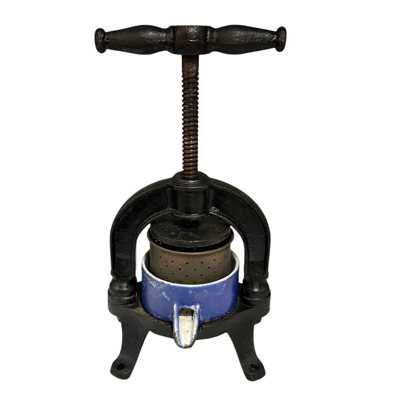 Vintage cast iron olive press with a blue container on a white background