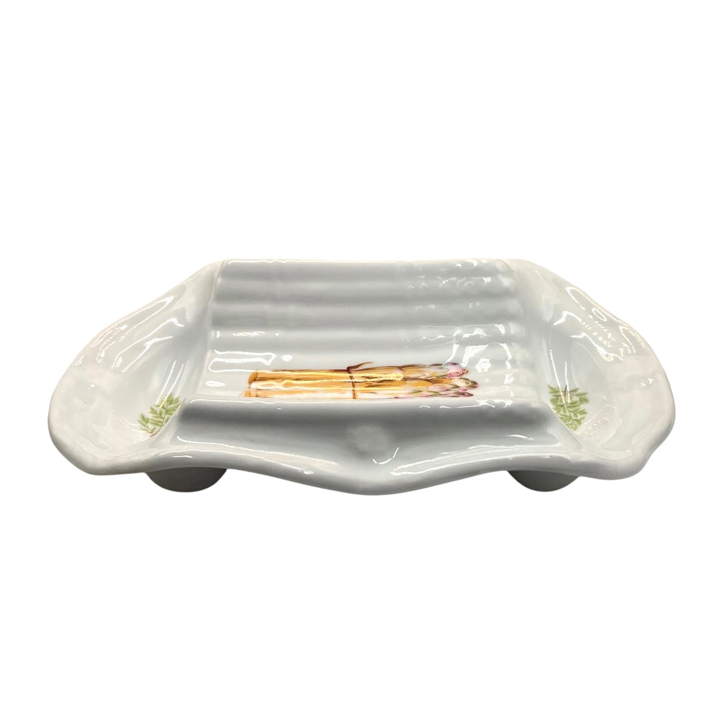 A white porcelain serving platter with a ribbed interior and asparagus illustrations near the corners, displayed on a white background