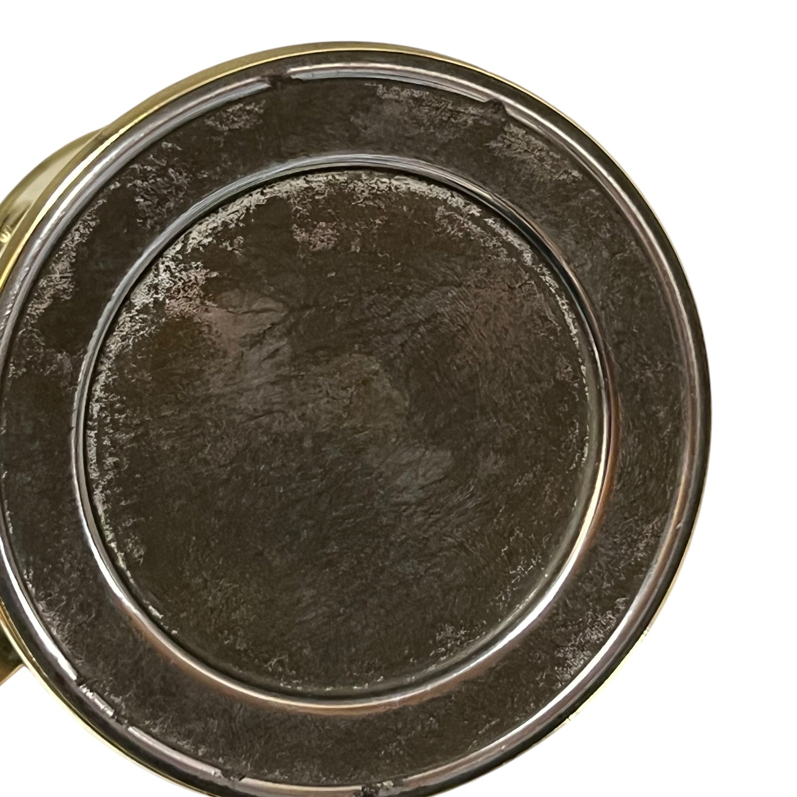 Close-up of a brass lamp base on a white background