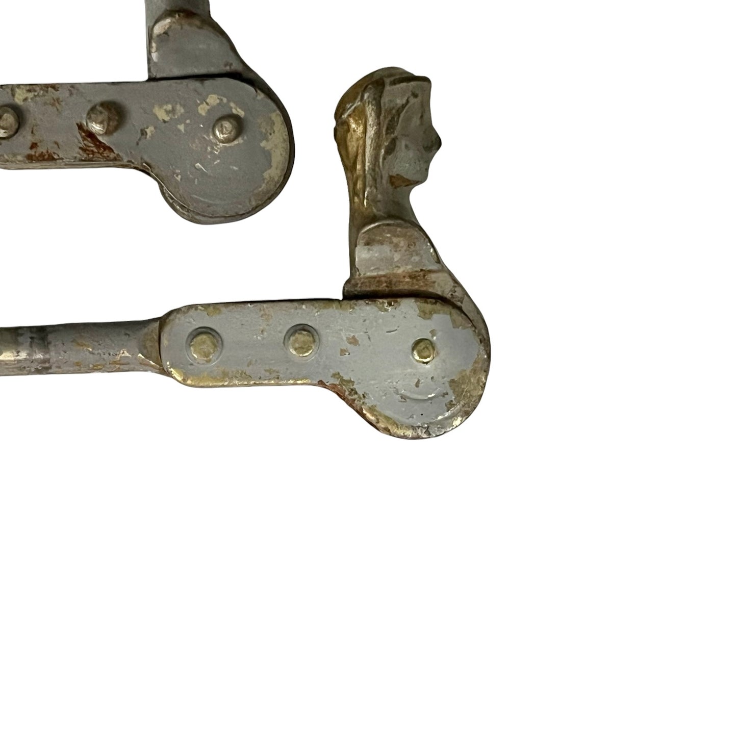 Close up of two rusty metal Belgian ladies shutter dogs on a white background