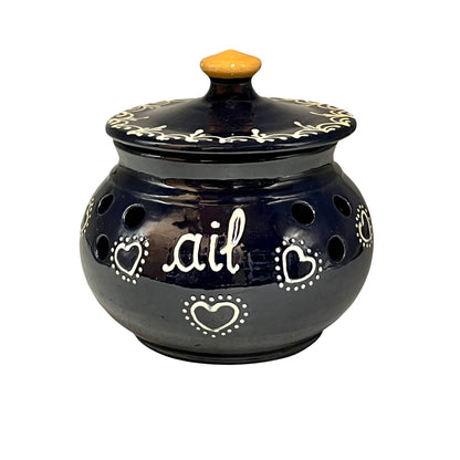 Blue ceramic pot with decorative hearts and the word 'ail' on a white background