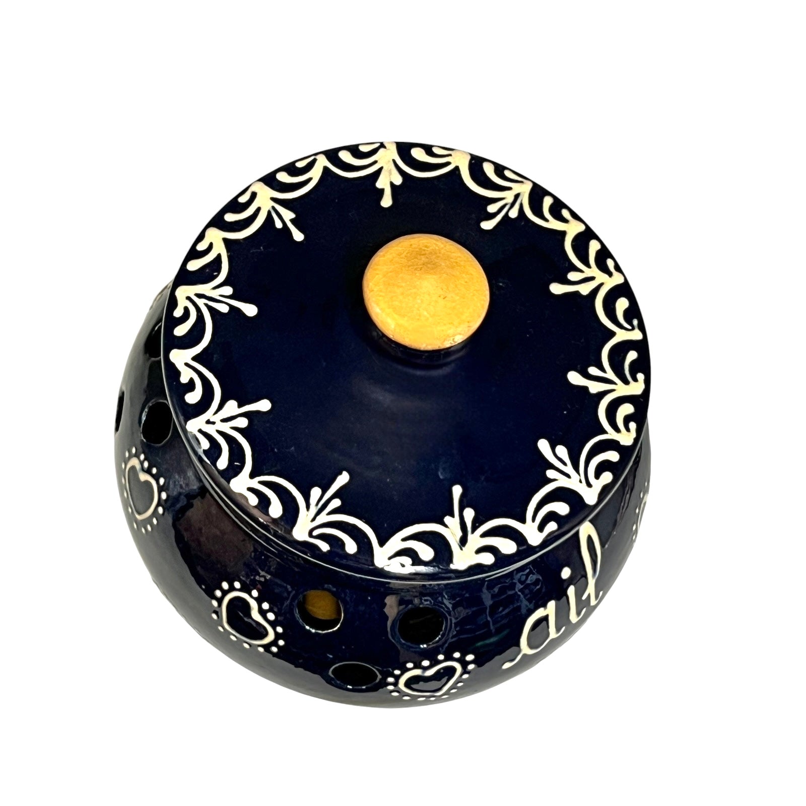 Decorative blue container with white patterns and a beige top on a white background