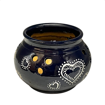 Blue ceramic pot with heart designs on a white background