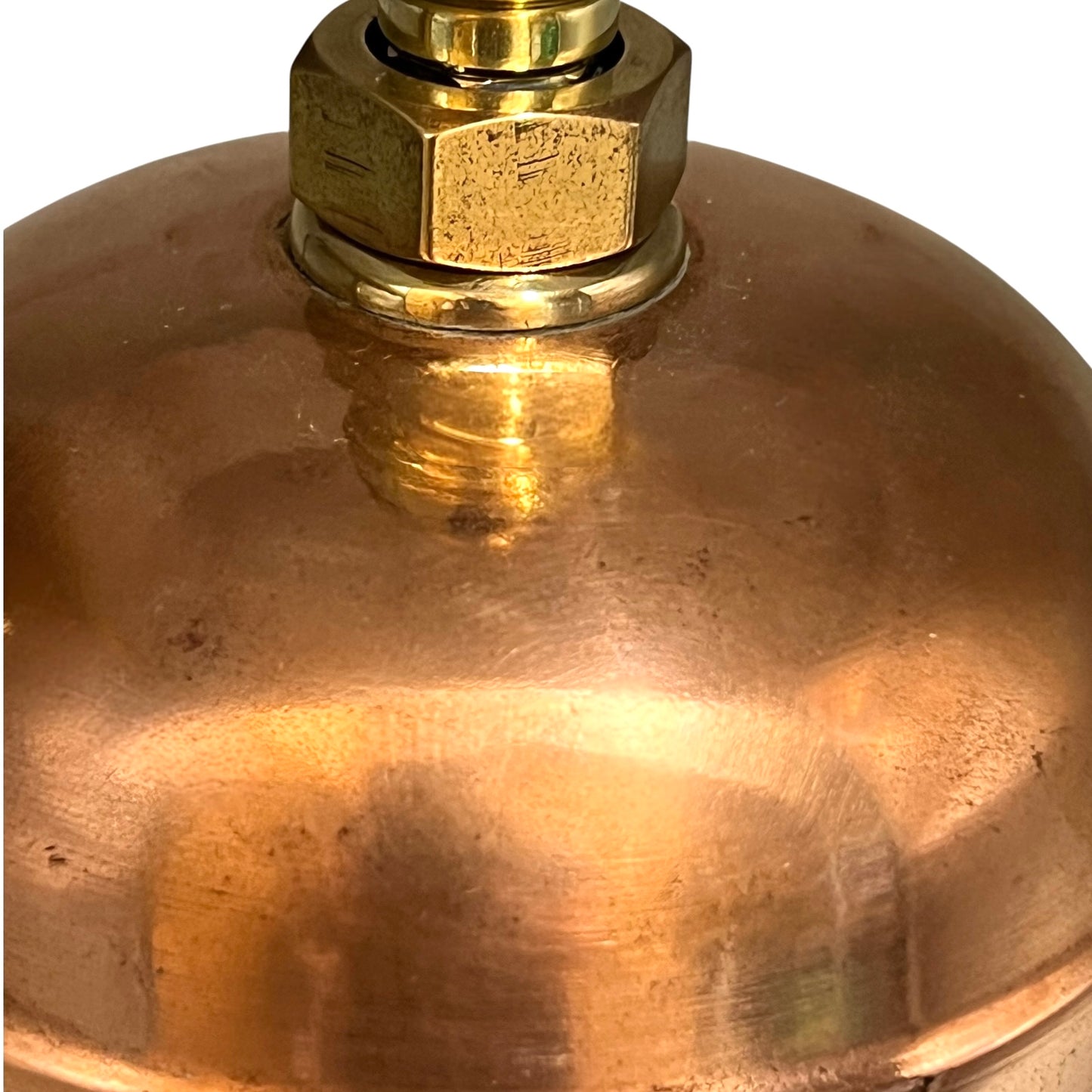 Close-up of a brass fitting on a copper lamp