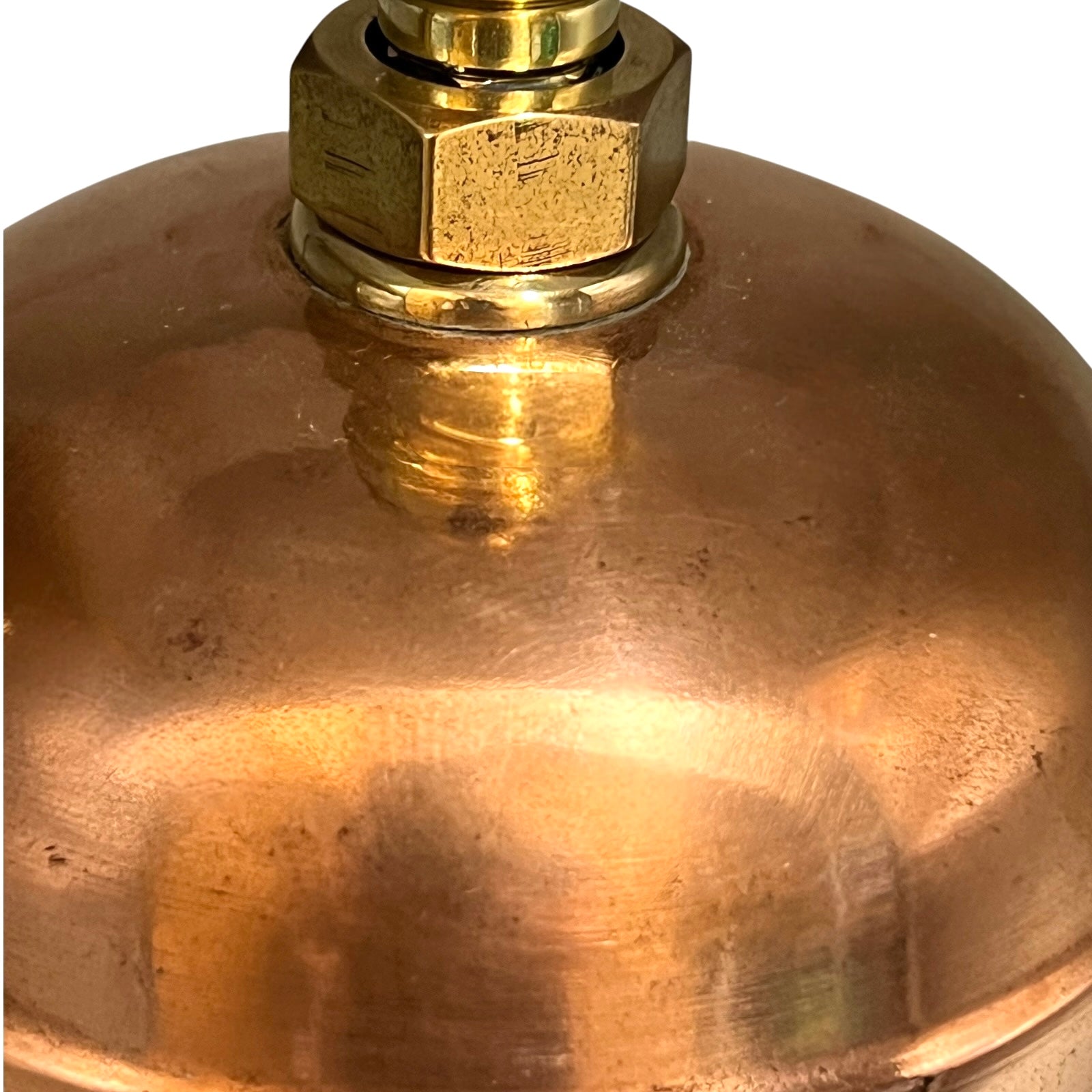 Close-up of a brass fitting on a copper lamp