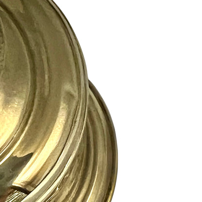 brass oil lamp showing small dent on a white background 