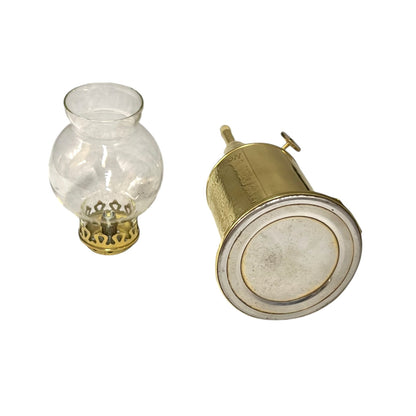 Vintage oil lamp with clear glass reservoir and brass base on a white background