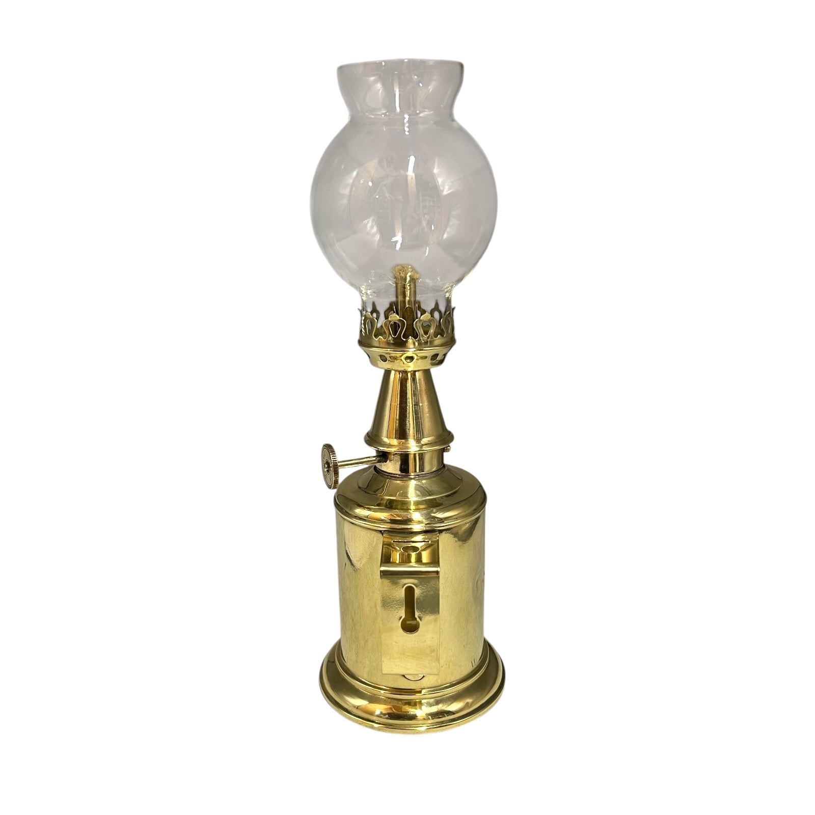 Brass oil lamp with a clear glass chimney on a white background