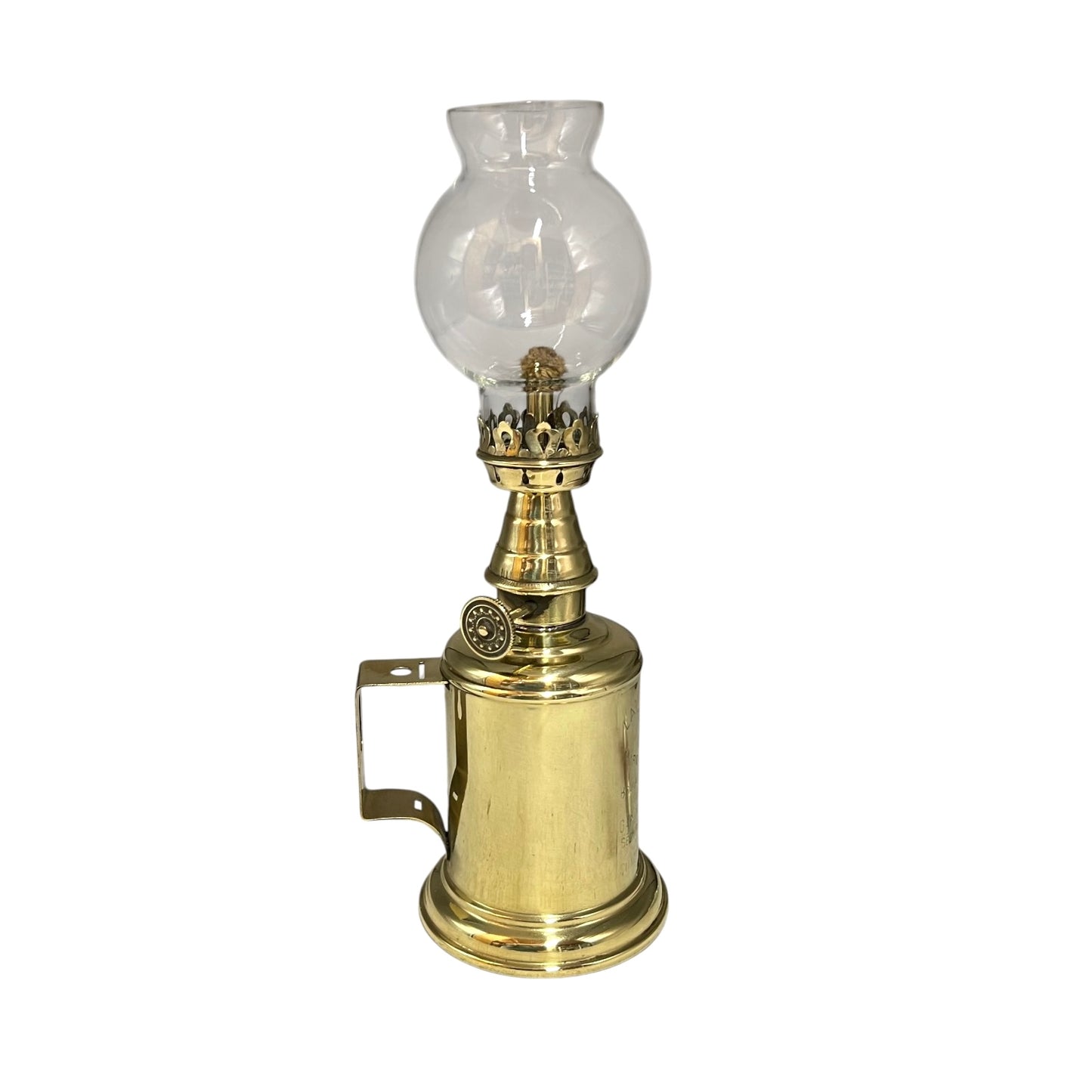 Brass oil lamp with clear glass shade on a white background
