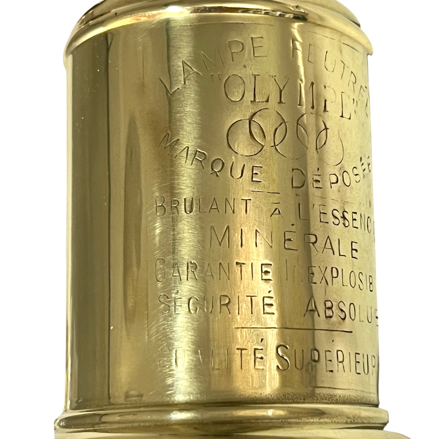 Brass lamp with engraved text on a white background