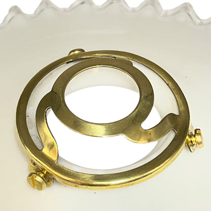 close up of french vintage milk glass pendant lampshade with a brass collar set on a white background 