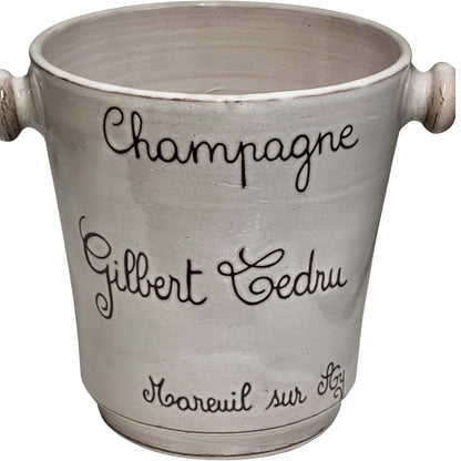 Ceramic champagne bucket with engraved text on a white background