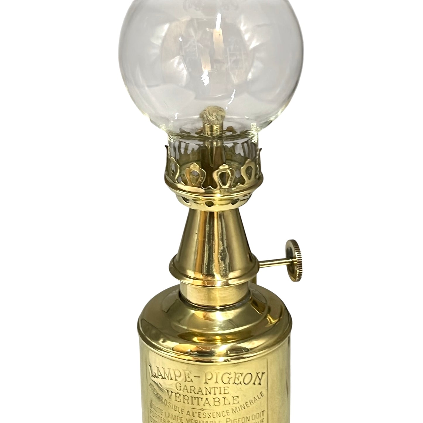Vintage-style brass lamp with clear glass globe on a white background