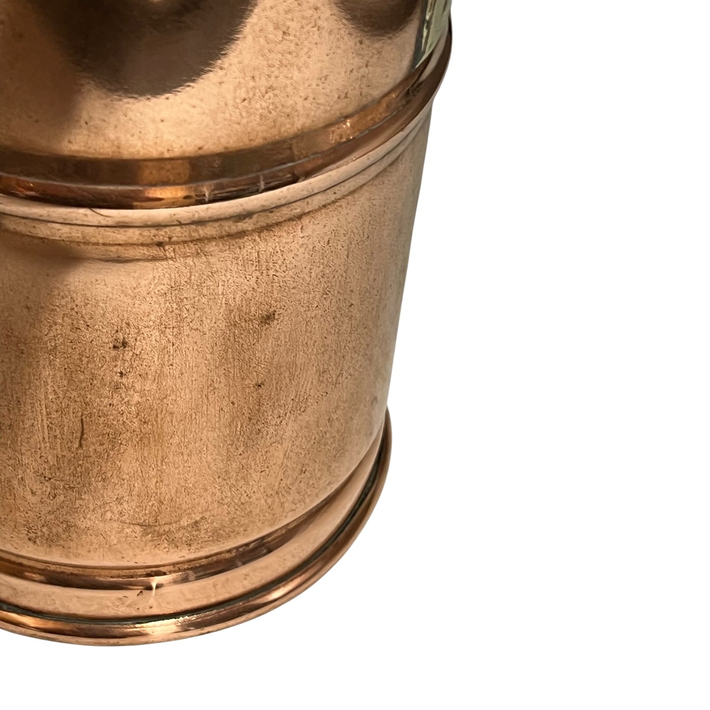Close-up of a copper and brass container on a white background