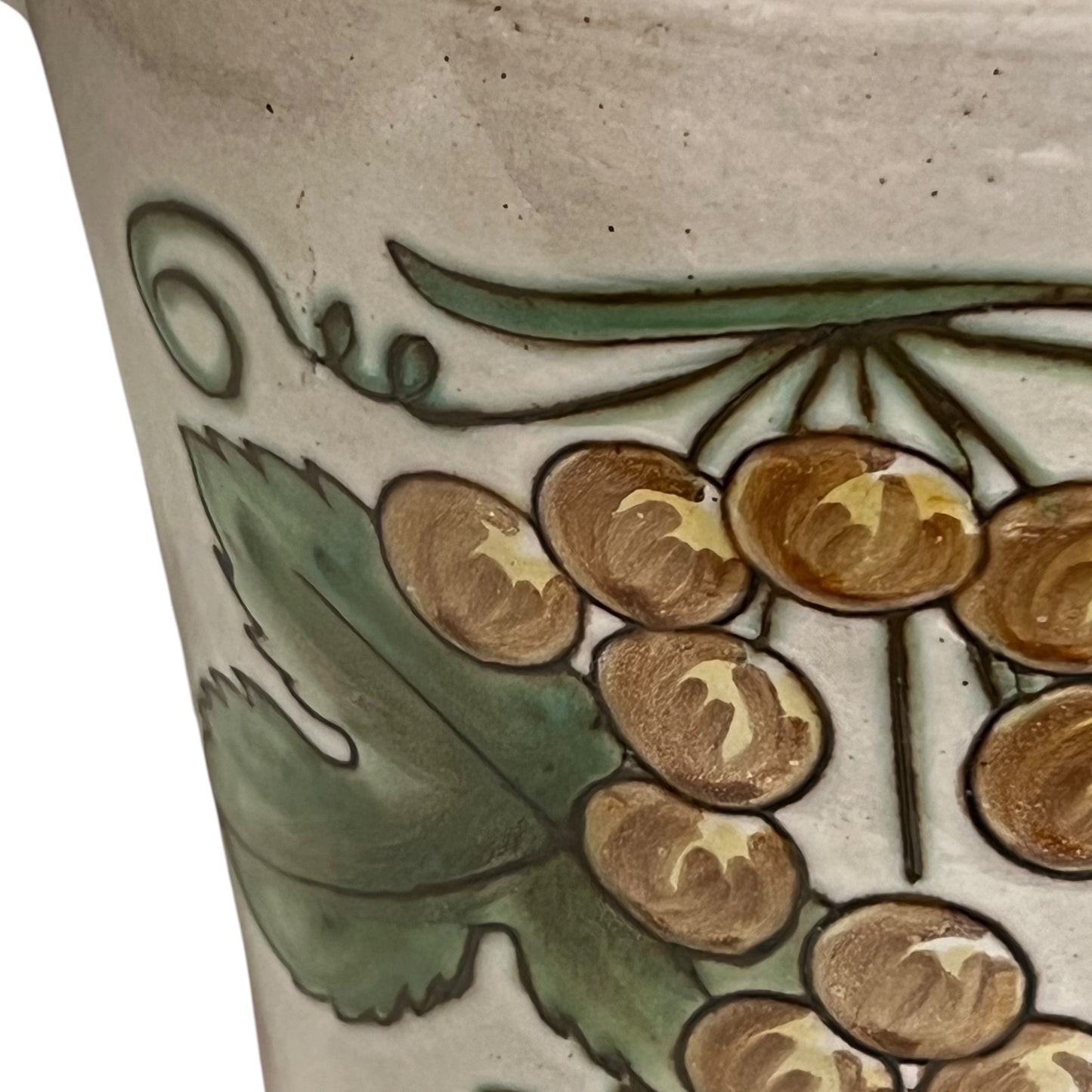 Ceramic pot with floral design on a beige background