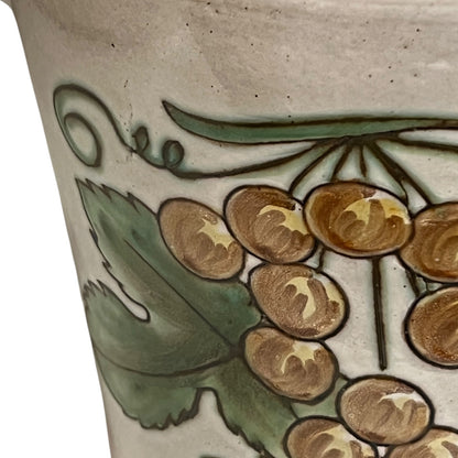Ceramic pot with floral design on a beige background