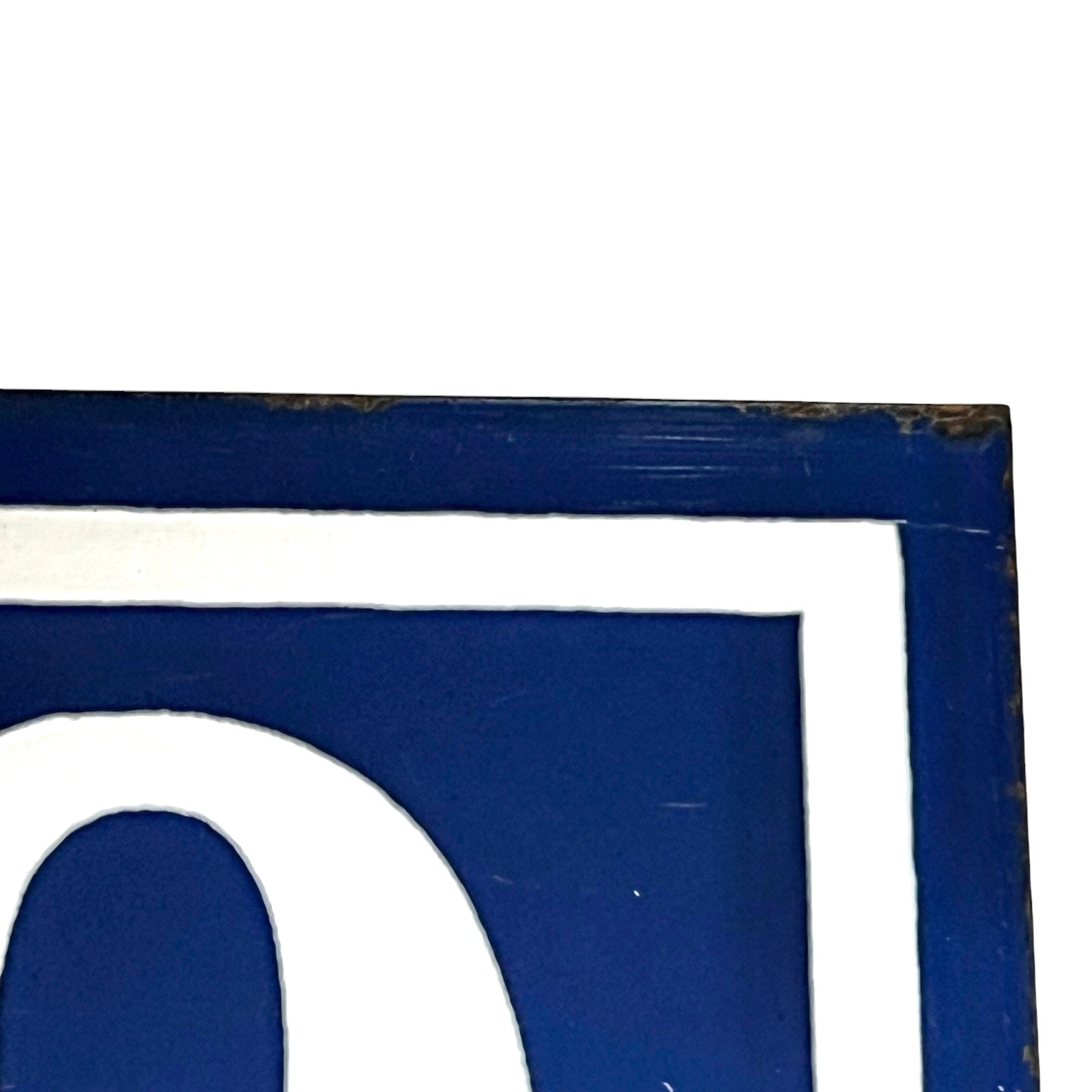 Close-up vintage French enamel door number against a white background.