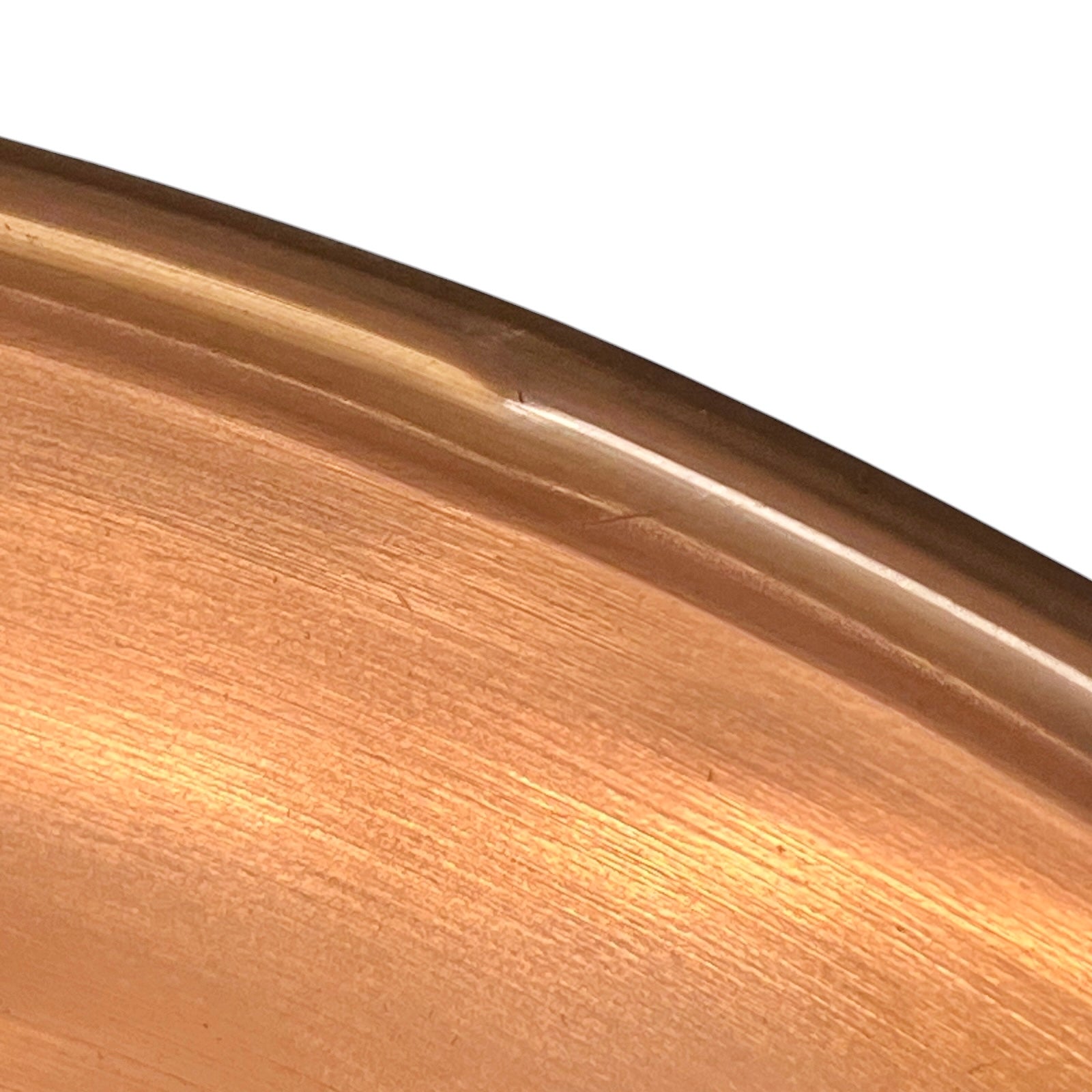 Close-up of a metallic surface with a reflective gold or bronze color.