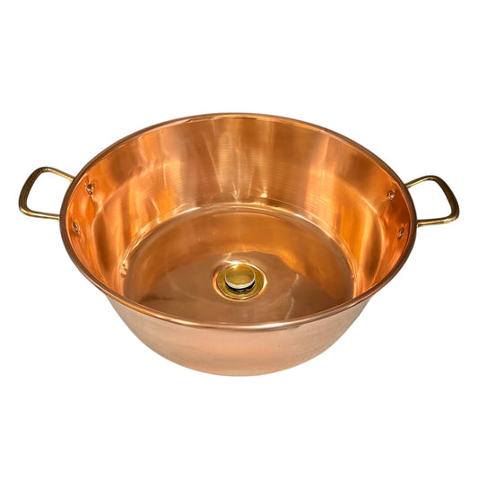 Copper sink bowl with brass handles and brass pop up waste on a white background