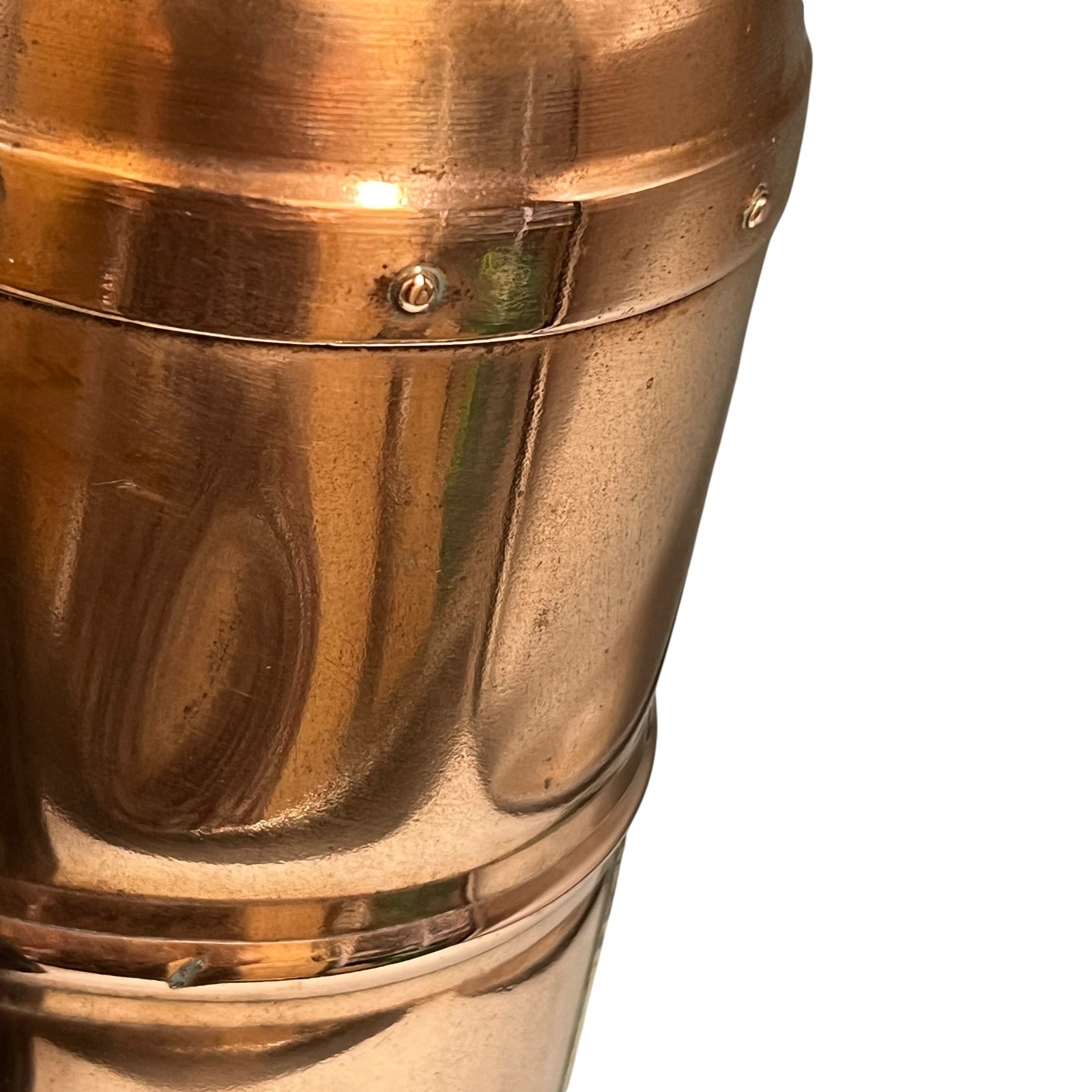 Close-up of a polished brass or copper object on a white background