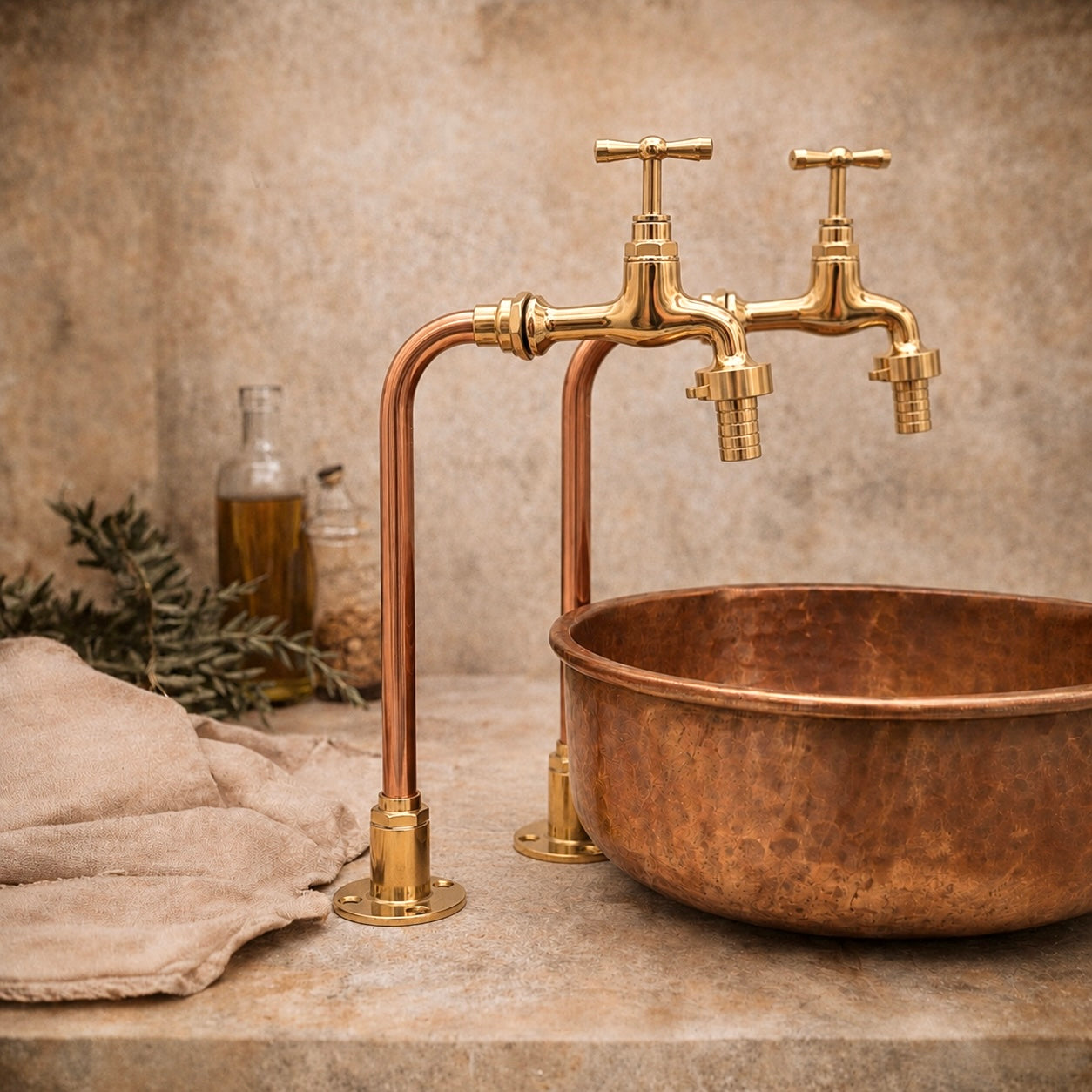 Copper sink with gold faucet on a stone surface