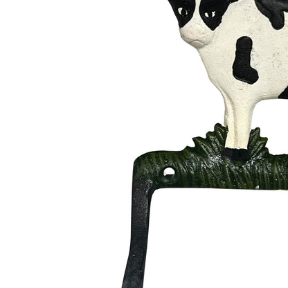 Decorative cow head with a green base on a white background