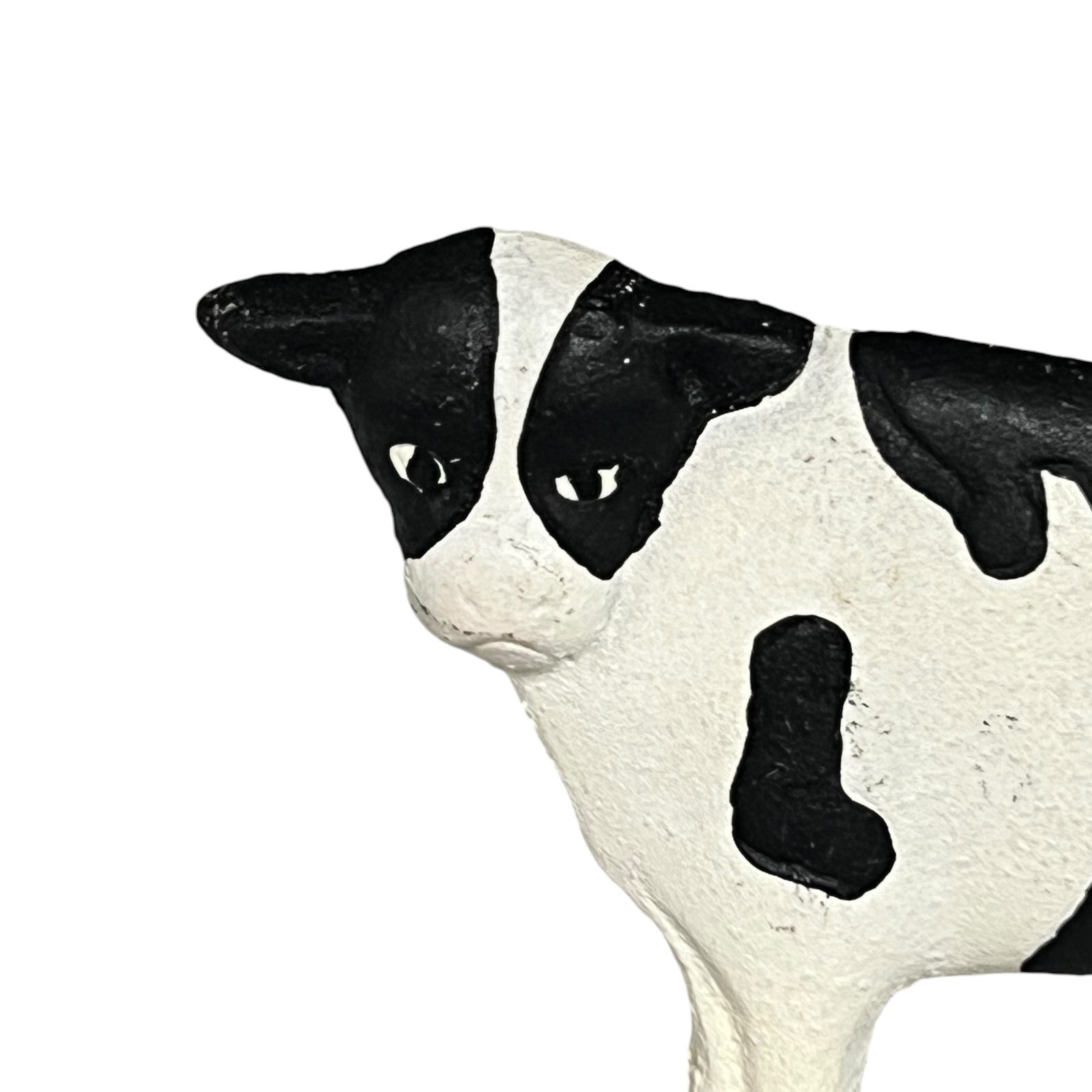 Black and white cow figurine on a white background