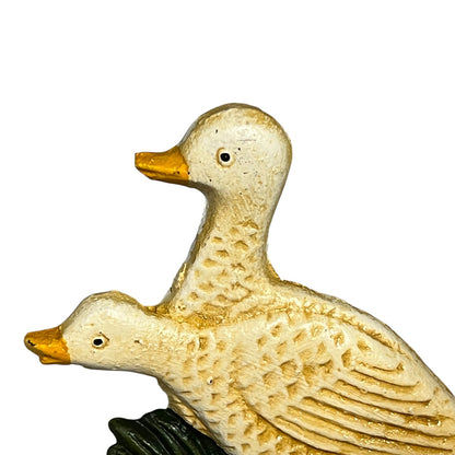 Two ceramic duck figures on a white background