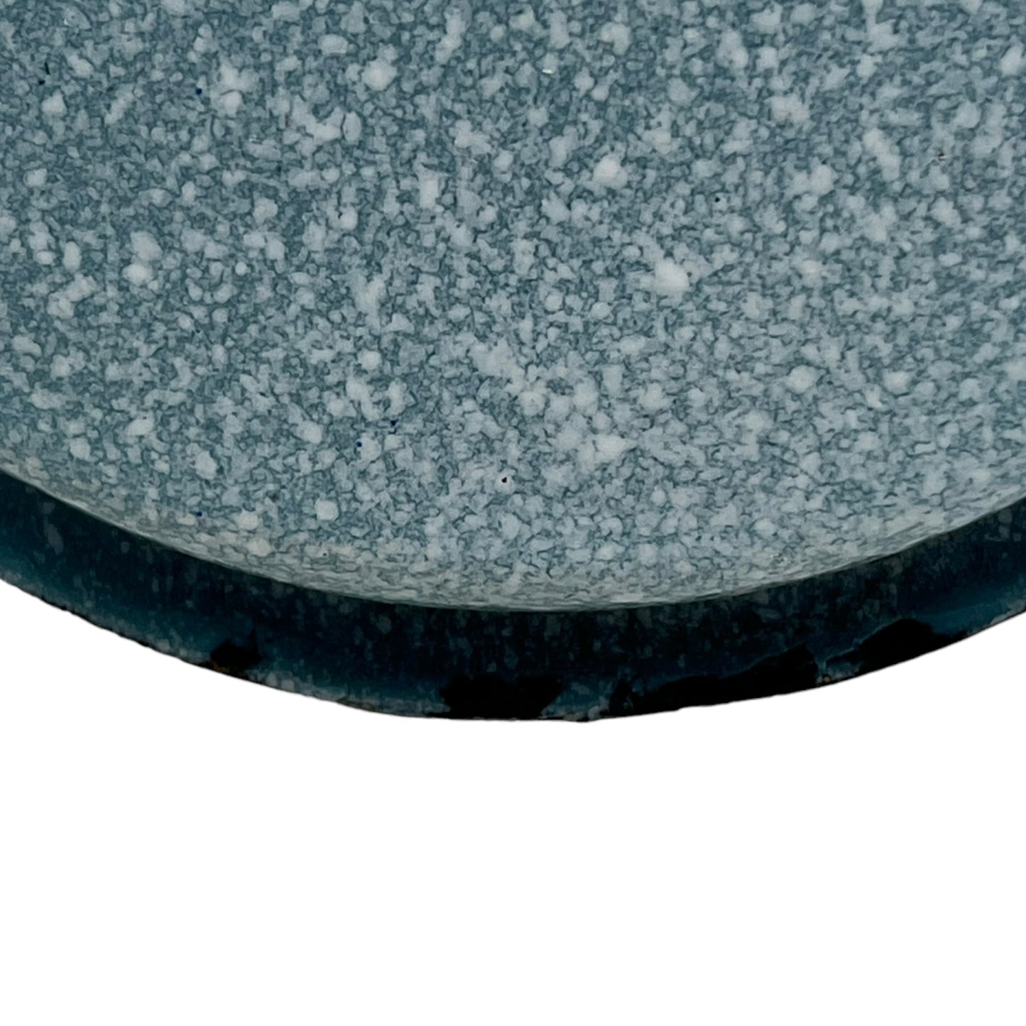 Close-up of wear and tear on a blue metal planter on a white background