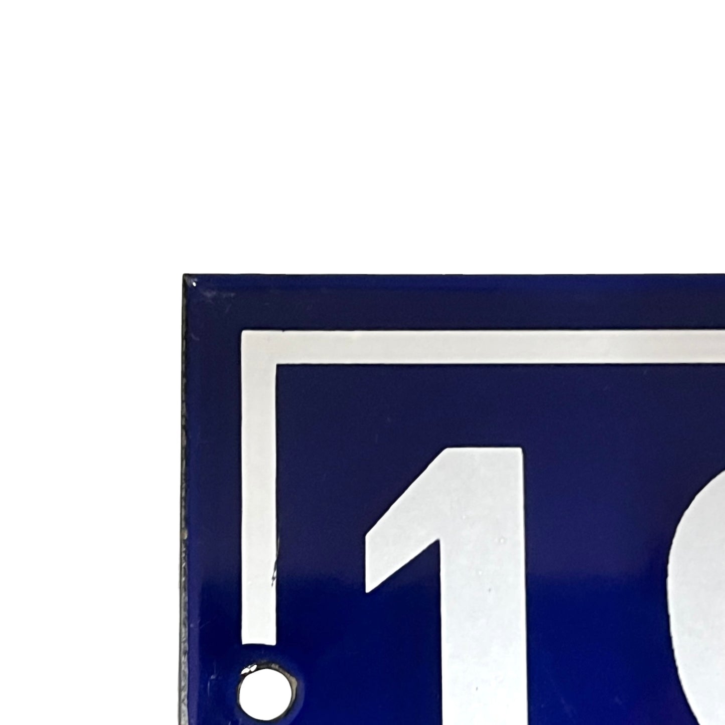 Close-up of a blue sign with a white arrow and number one on a white background