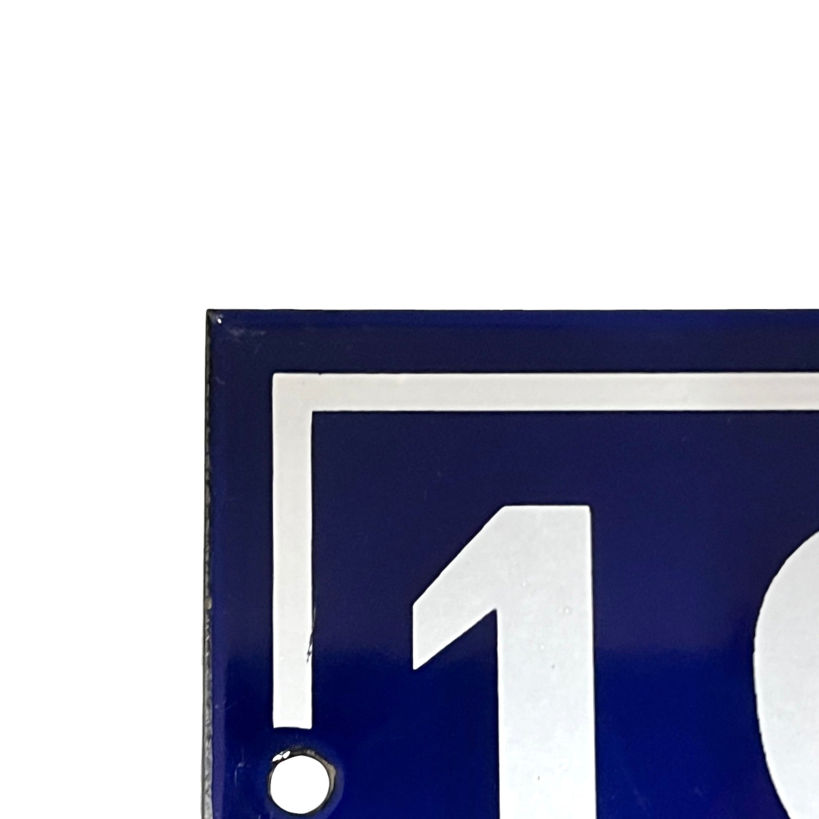 Close-up of a blue sign with a white arrow and number one on a white background